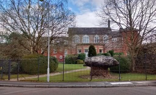 Side of Rose Hill House with the Shar Stone, a glacial boulder brought by Edward Watkin in about 1892. Sir Edward Watkin was a Member of Parliament and a leading railway entrepreneur of the Victorian Age.